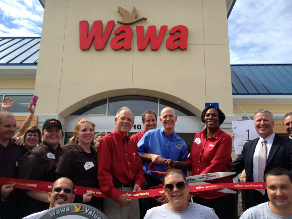 Florida Governor Rick Scott  stands in front of the First Wawa store in Florida.